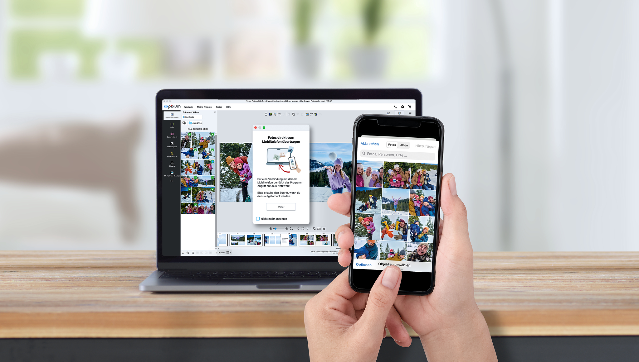Laptop mit der Pixum Fotowelt Software und einem QR-Code zur Übertragung von Handyfotos auf den PC