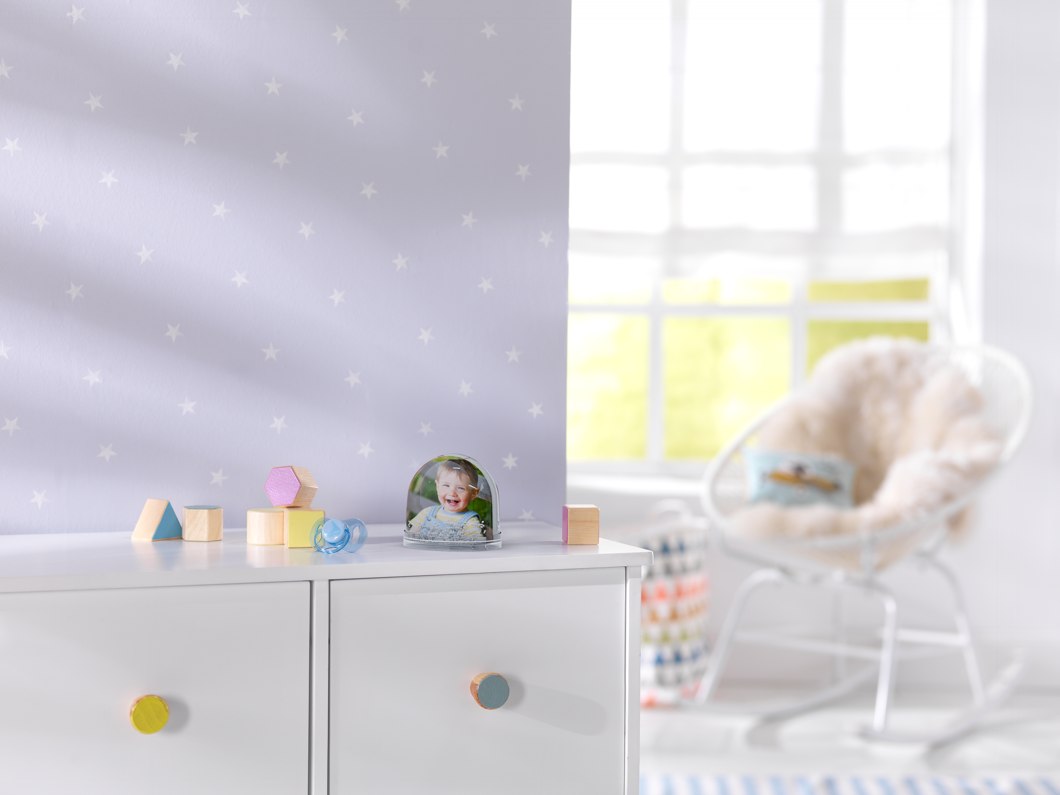 Schneekugel mit einem Foto von einem kleinen Kind steht in einem Kinderzimmer