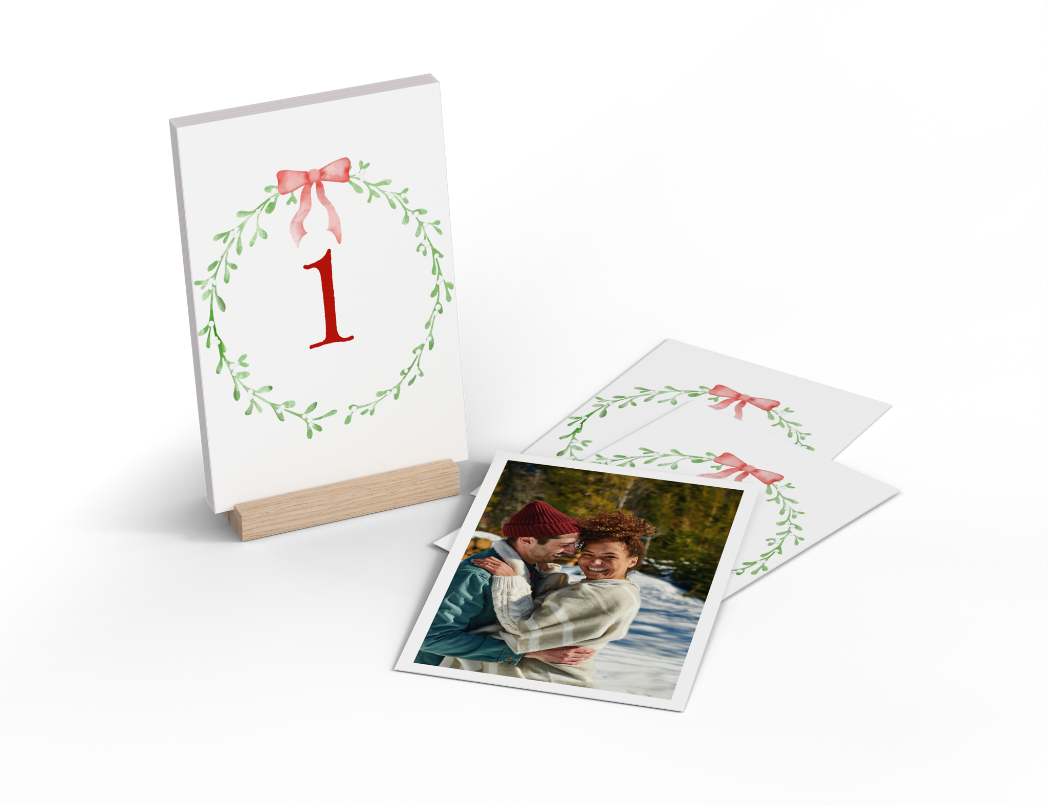 Tisch-Adventskalender aus 24 personalisierten Fotokarten mit Mistelzweig-Design auf der Rückseite.