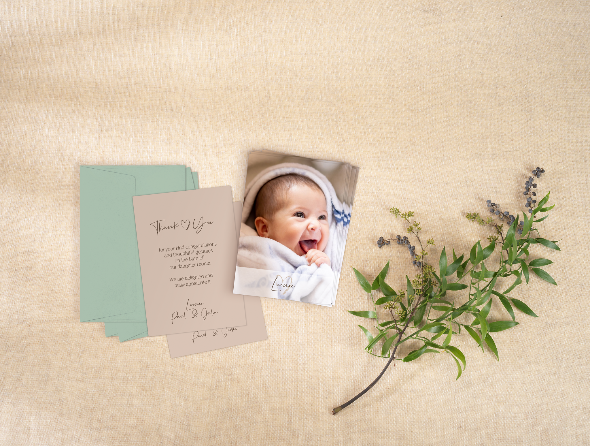 Photo birth cards with baby photo and text on a table