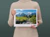 Pixum Fotobuch groß im Querformat mit einer Schweizer Berglandschaft auf dem Cover