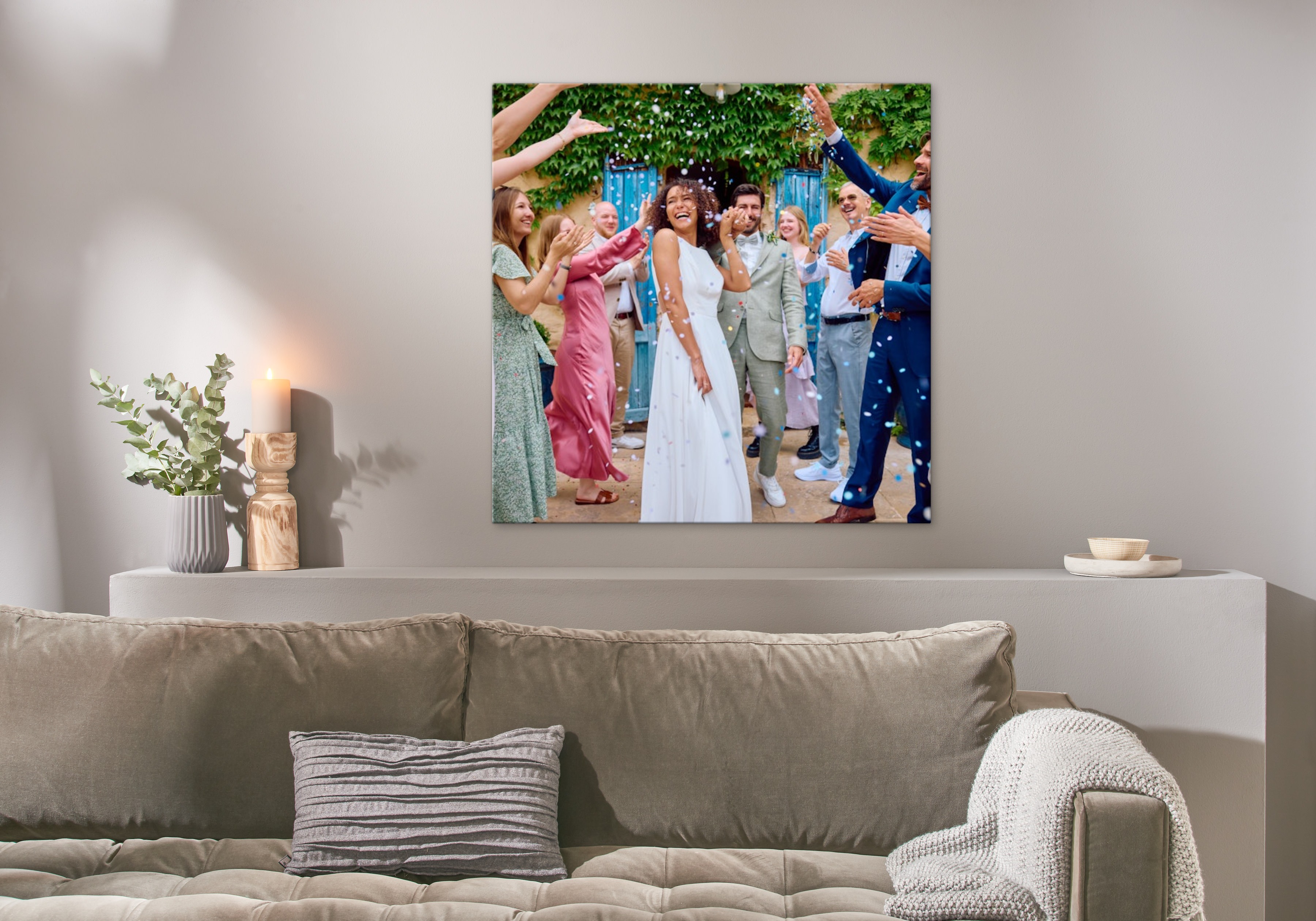 Eine Fotoleinwand im Format 100x100 cm hängt an einer Wand und zeigt ein Bild von einer ausgelassenen Hochzeitsfeier.