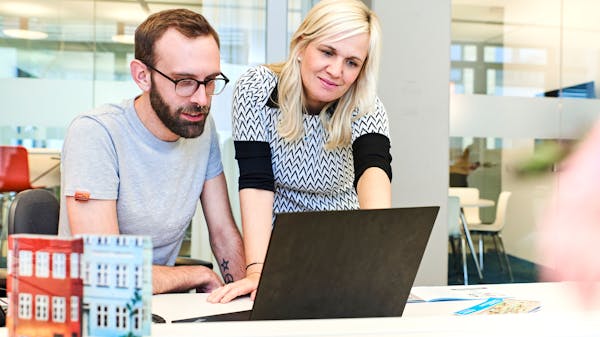 Passwort vergessen Zwei Mitarbeiter:innen des Pixum Kundenservice bei der Arbeit