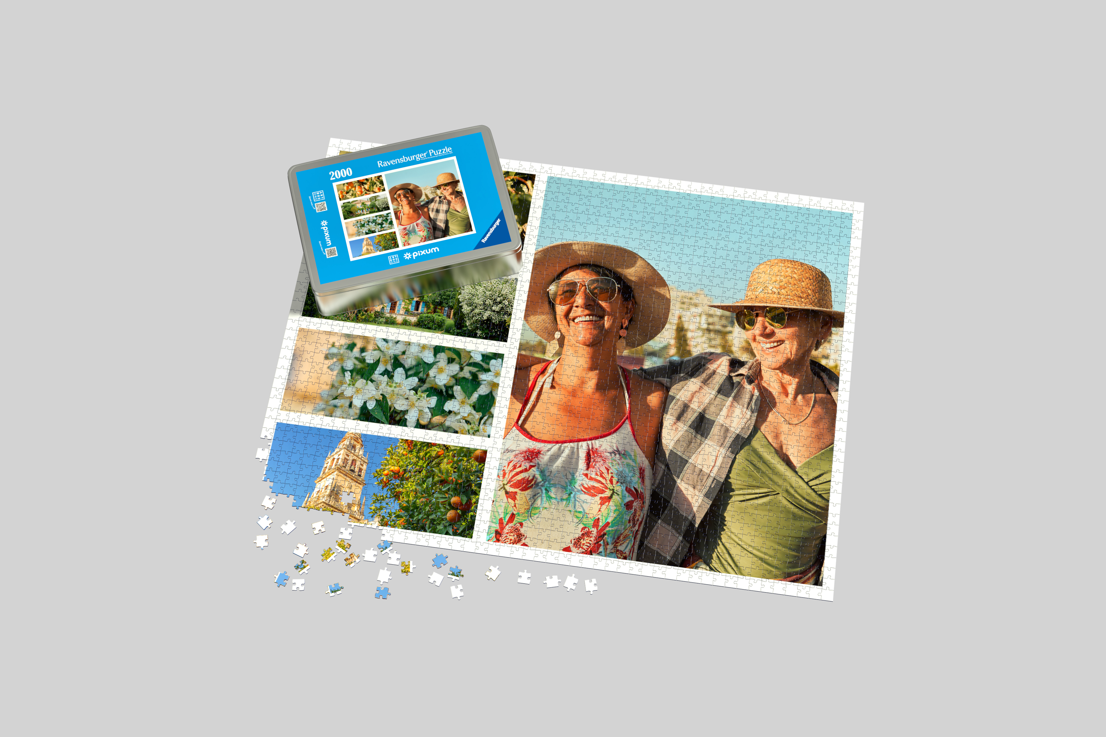 Een fotopuzzel van Ravensburger met 2000 stukjes en een fotocollage erop. De bijbehorende metalen opbergdoos ligt erbij.
