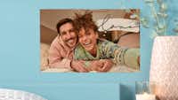 Poster photo Pixum Poster photo Pixum avec une photo de couple sur un mur bleu