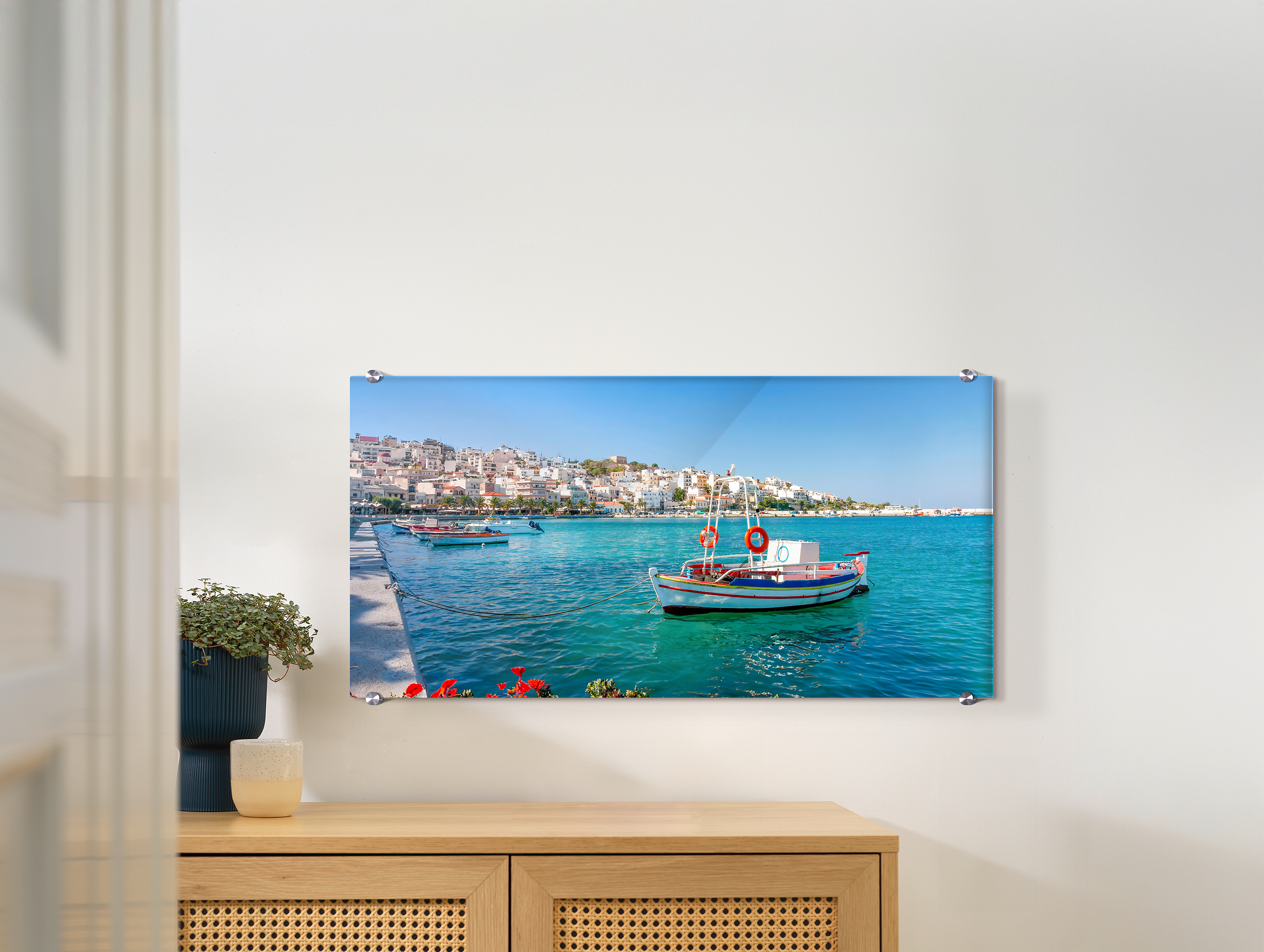 Ein Wandbild aus Acrylglas hängt an einer Wand. Darauf ist ein Urlaubsmotiv abgebildet.