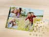 Photo puzzle with collage of several family photos in spring, on a table