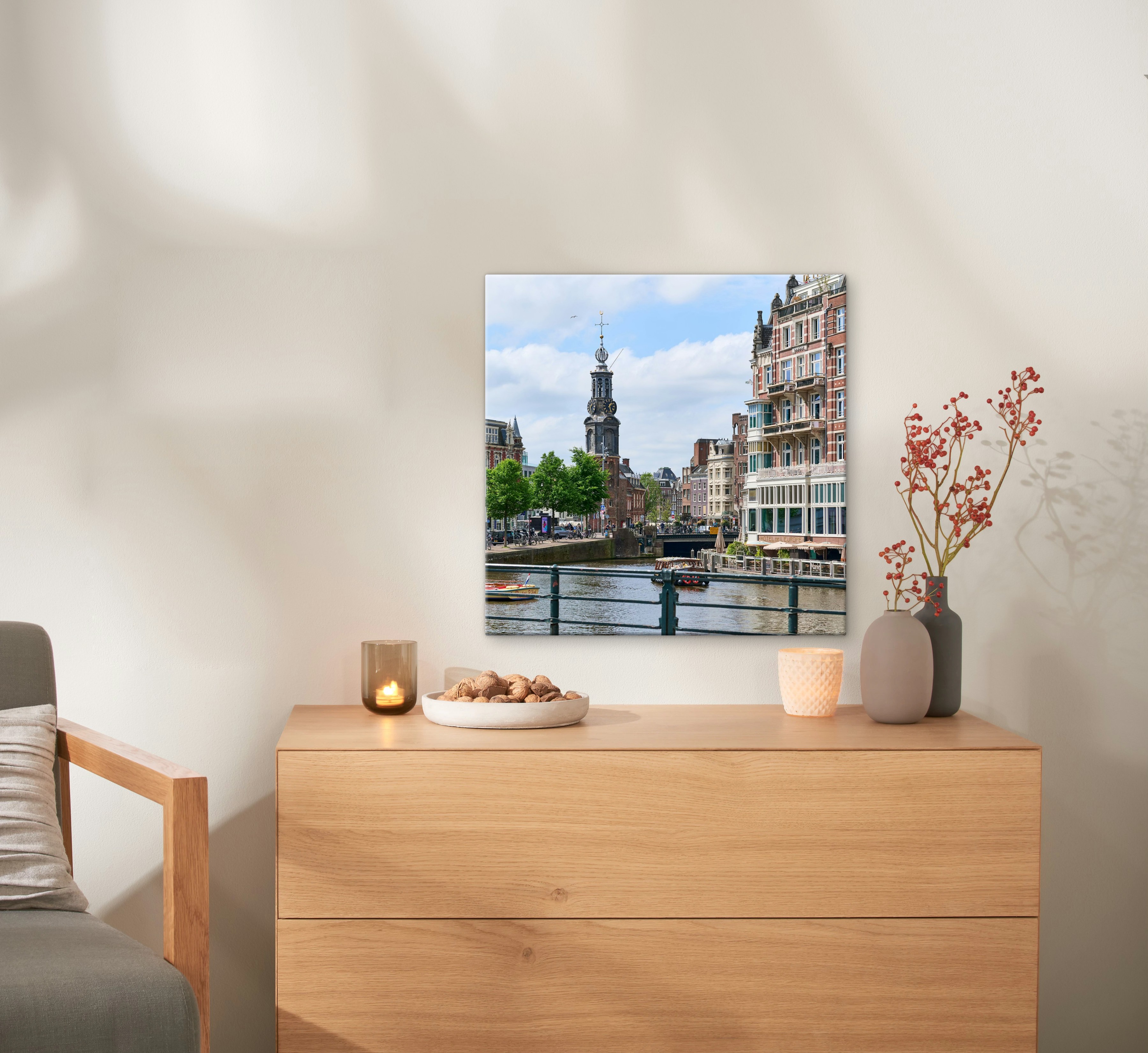 Een canvas in het formaat 50x50 cm met een foto van Amsterdam hangt aan de muur.