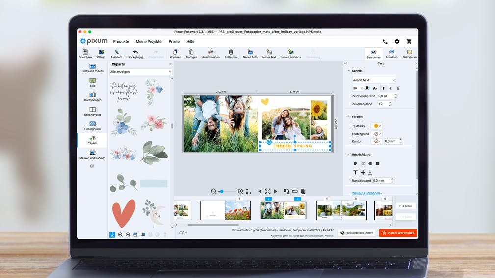 Laptop met Pixum Fotowereld Software en een fotoboekontwerp met cliparts