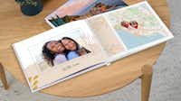 Álbum Digital con mapas y rutas Un álbum de fotos desplegable muestra una foto de dos de amigas viajando juntas a la izquierda y un mapa de su ruta a la derecha.