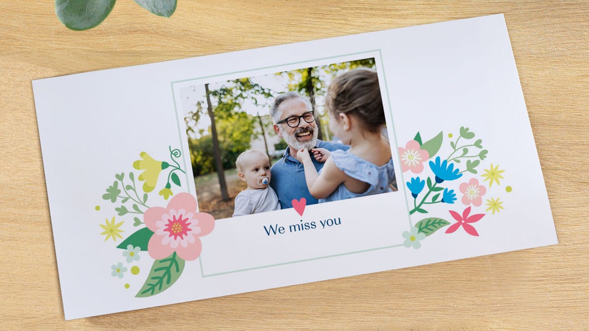 Photo greeting card with a family picture and the text "We miss you"