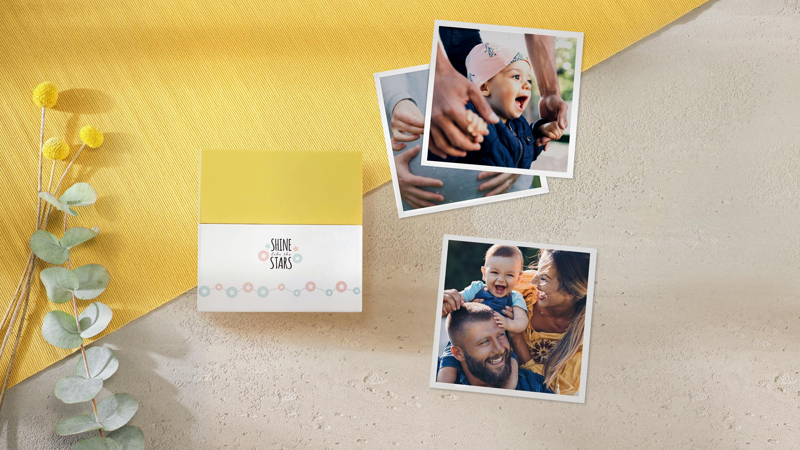 Square-Prints mit Baby-Fotos und einer Box im passenden Design